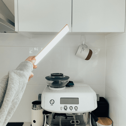 Rechargeable motion sensor strip light illuminating kitchen counter